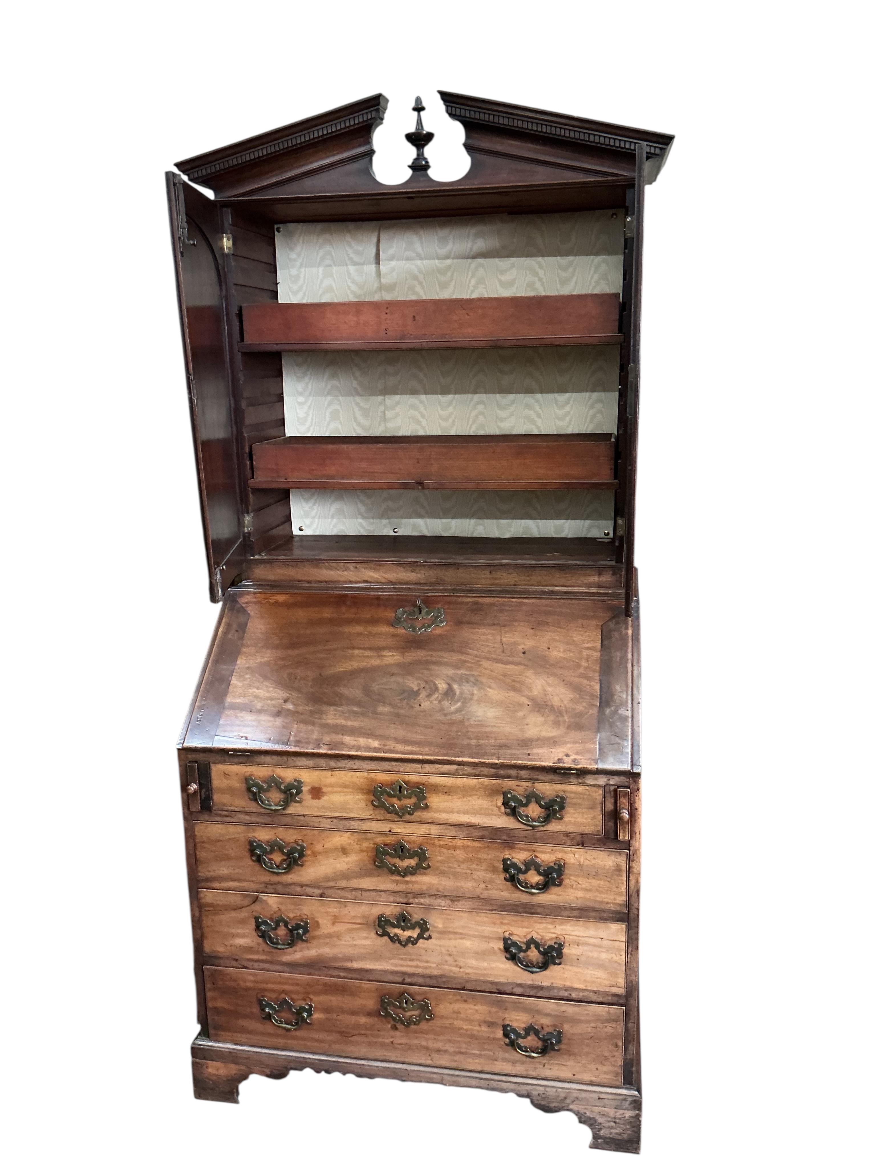 A small George III mahogany bureau cabinet with broken arch pediment, width 95cm, depth 62cm, height 198cm